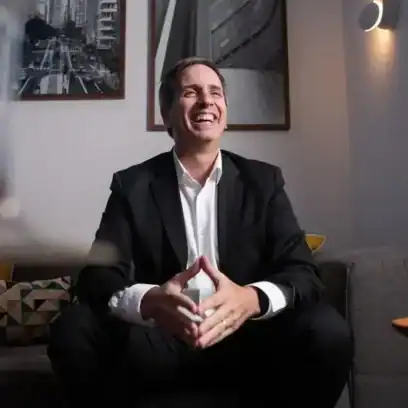 man smiling in white shirt and black suit