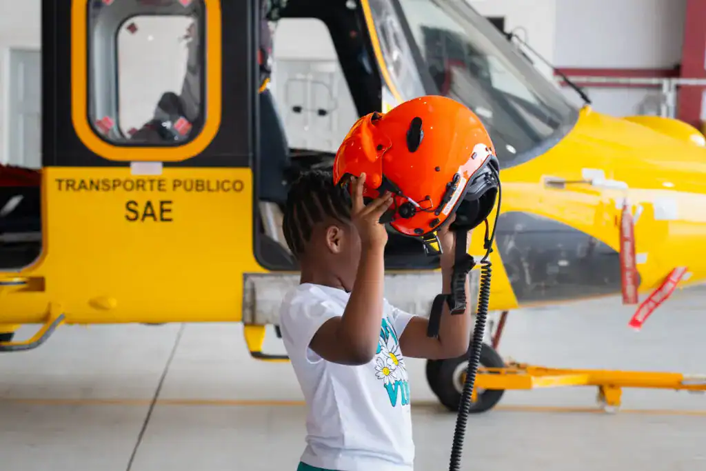 yellow helicopter and child with a red helmet
