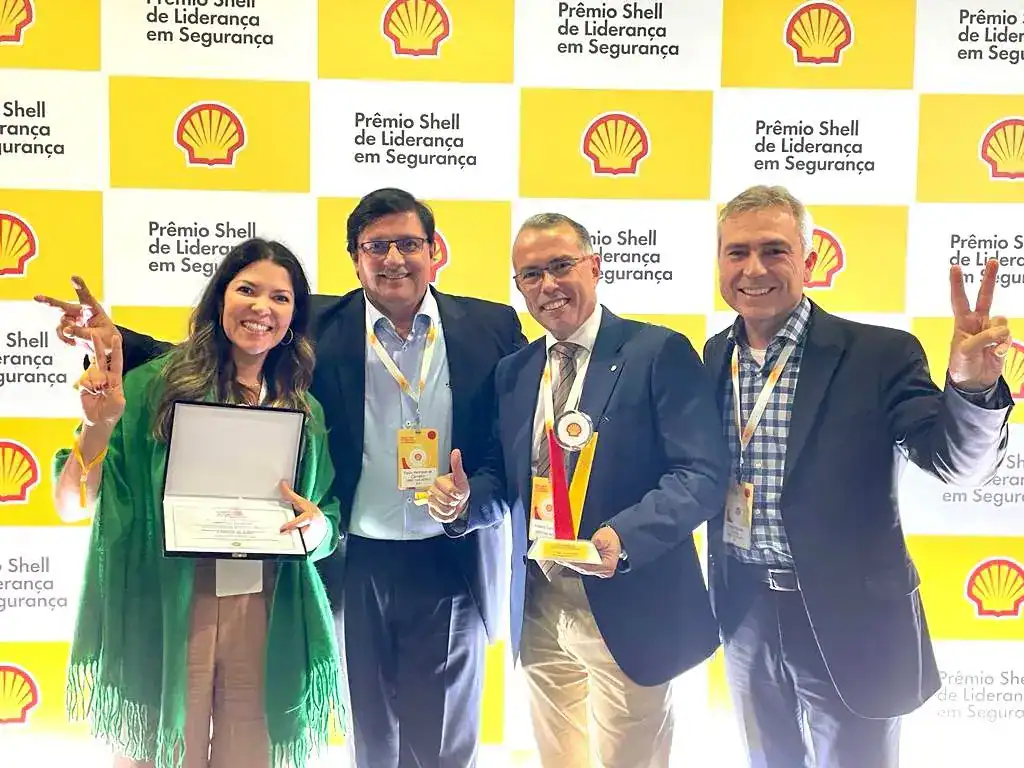 one woman and three men smiling